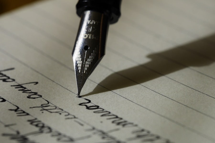 Handwritten story notes beside a keyboard